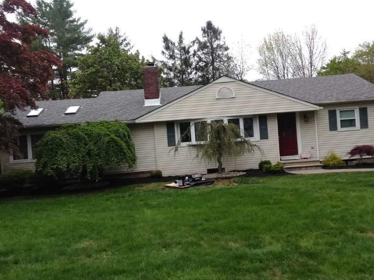 A house with a large lawn in front of it
