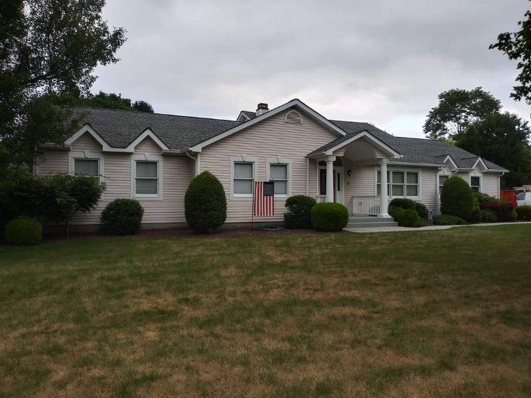 A white house with an american flag in front of it