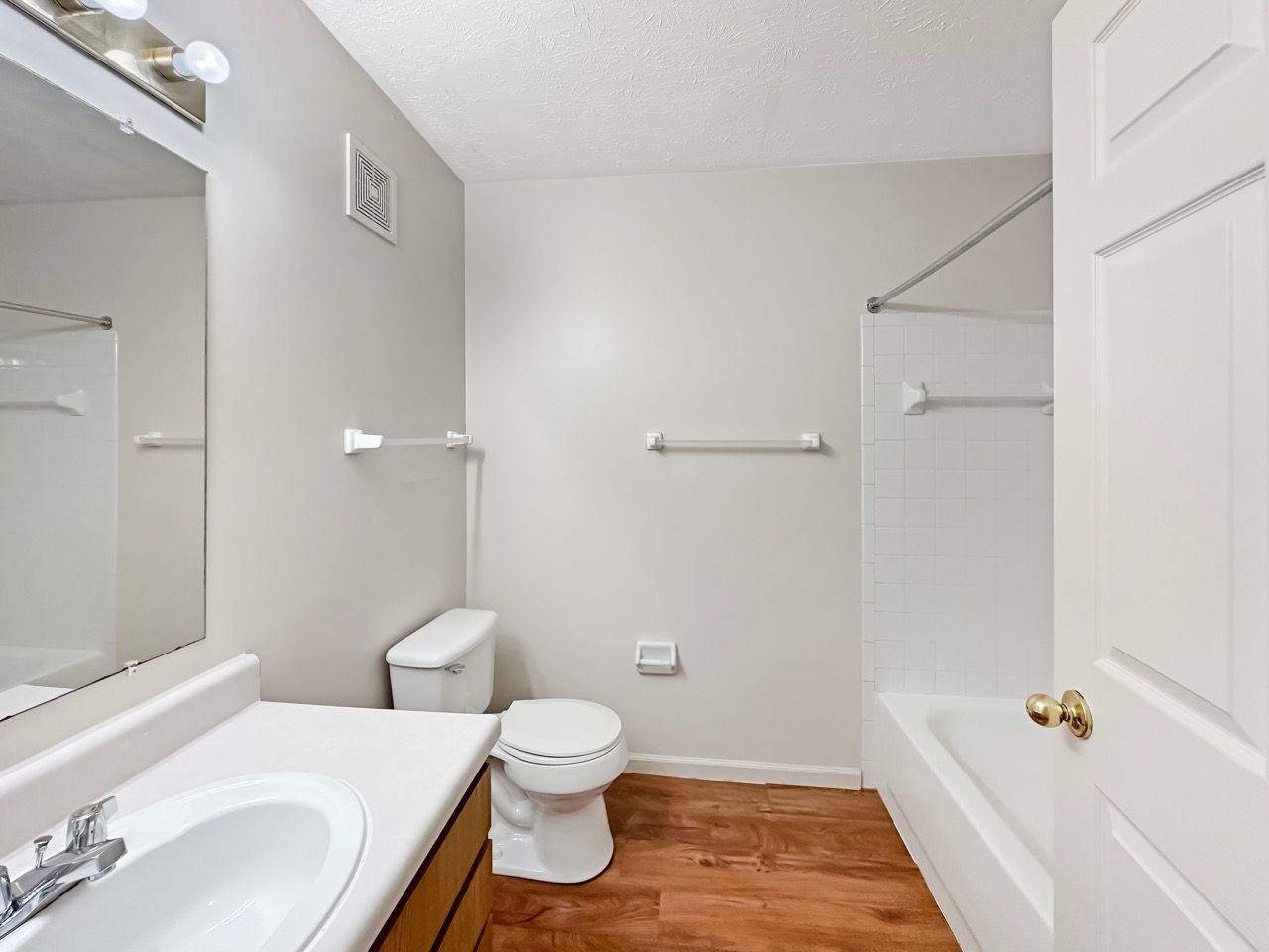 A bathroom with a toilet , sink and bathtub