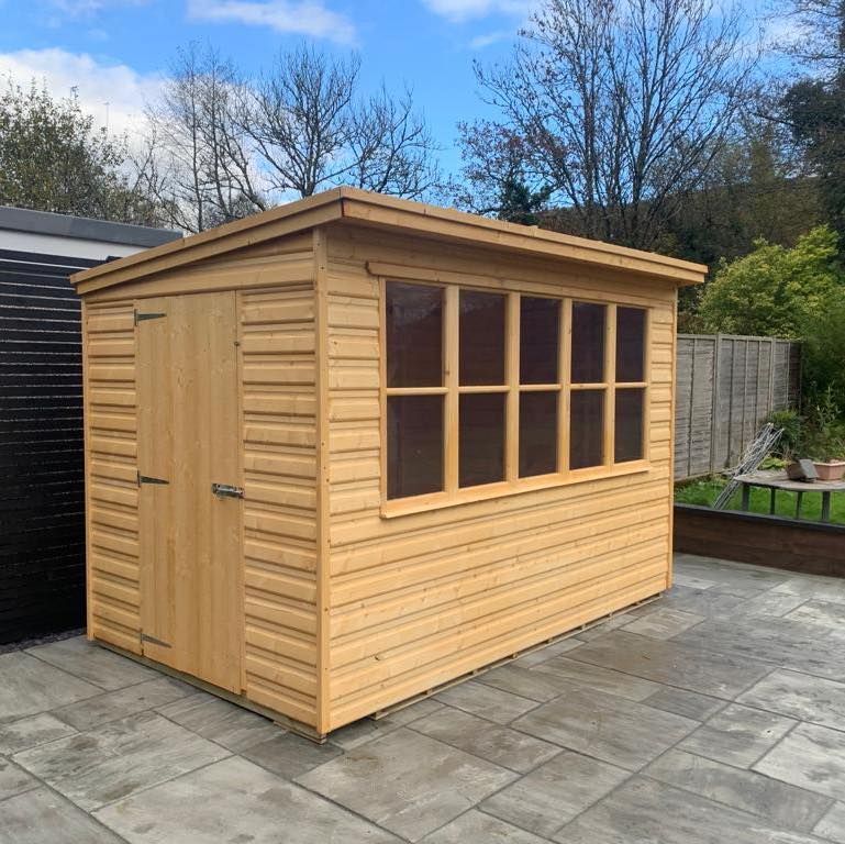 10' x 6' Pent shed used as a potting shed. Our summerhouse modern windows along one side.
