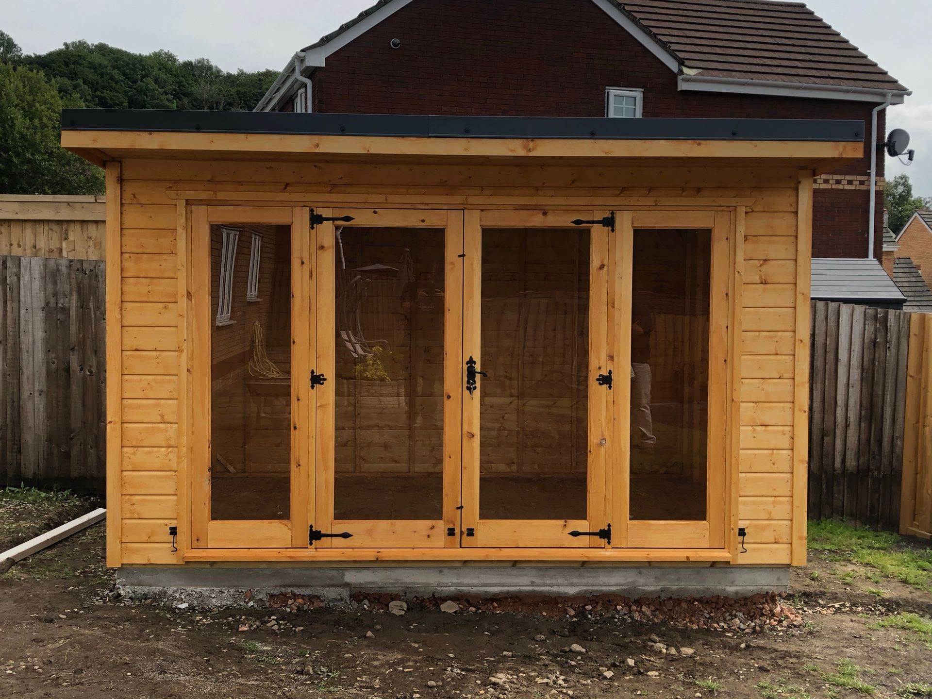 Wooden Contemporary Summerhouse with full pane doors and windows either side of the doors. Mortice lock and key starting from 9' wide and can go as deep and wide as you want. 12' x 8' Pent contemporary pictured.