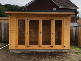 Wooden Contemporary Summerhouse with full pane doors and windows either side of the doors. Mortice lock and key starting from 9' wide and can go as deep and wide as you want. 12' x 8' Pent contemporary pictured.