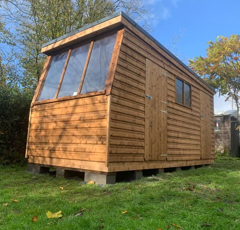 16' x 7' Potting shed with half windows. Stable doors on both doors with division and metal box profile sheets on the roof. Double window on the side to allow light in the other space.