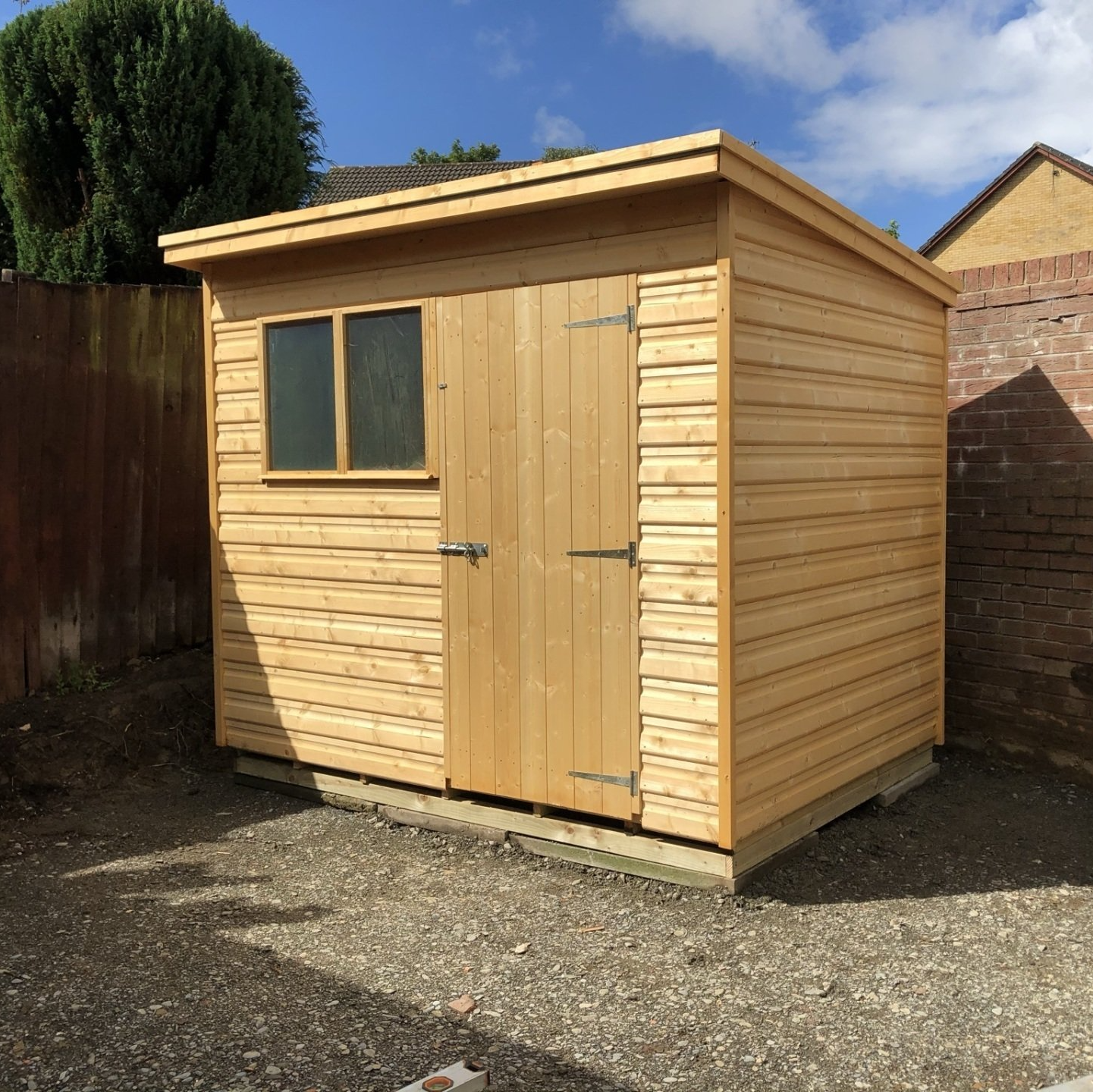 8' x 6' Pent shed sloping front to back with double windows on the left and door on the right