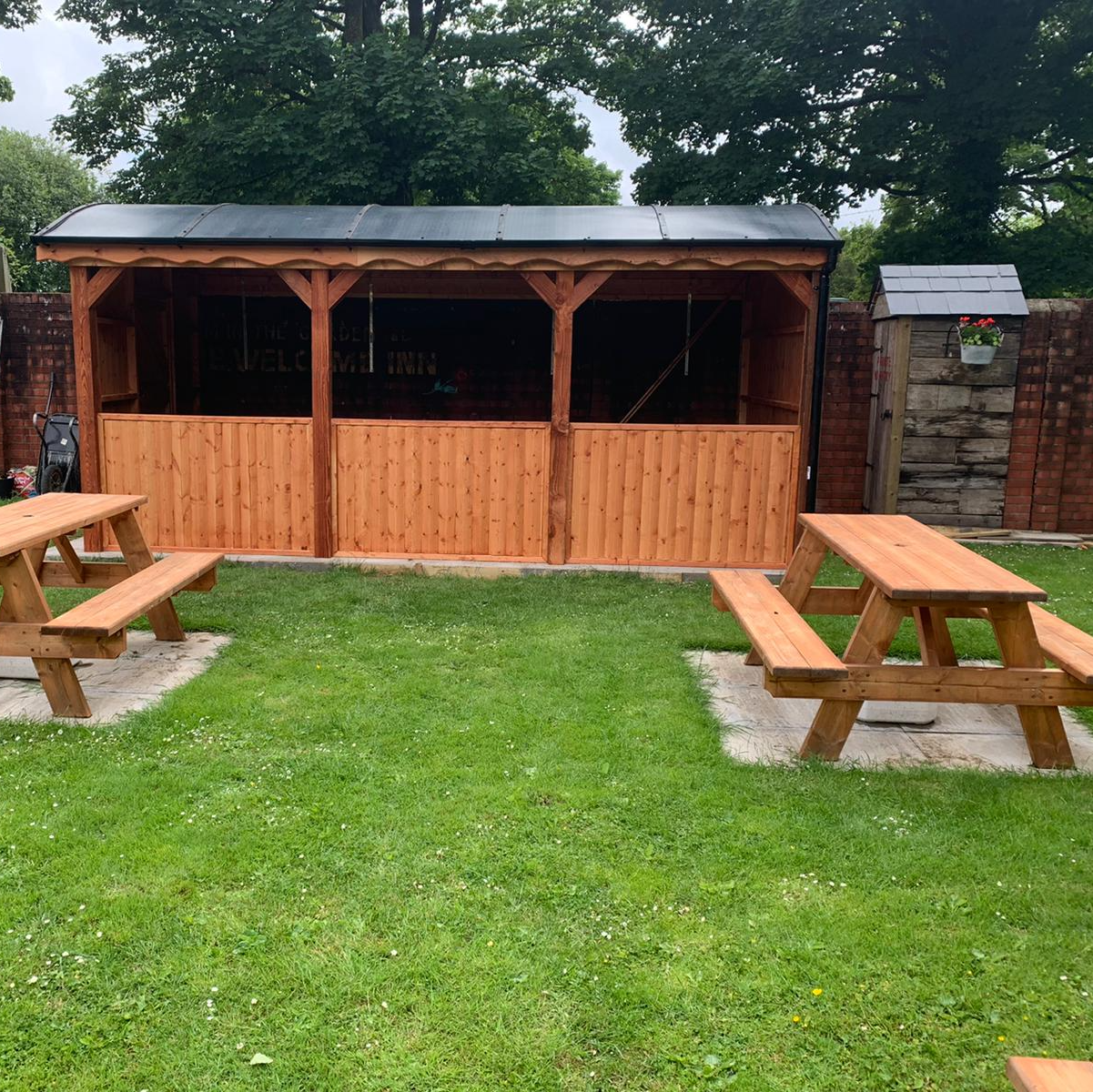 Curved roof serving bar in the gardens of The Welcome Inn in swansea