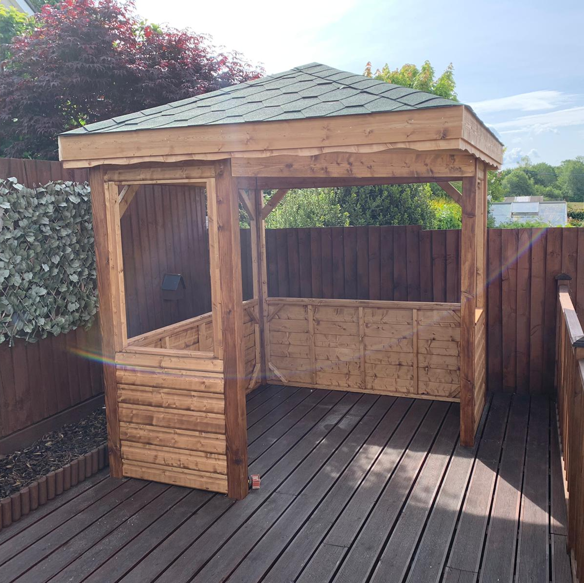 Square gazebo with shingles on roof in design by the customer.