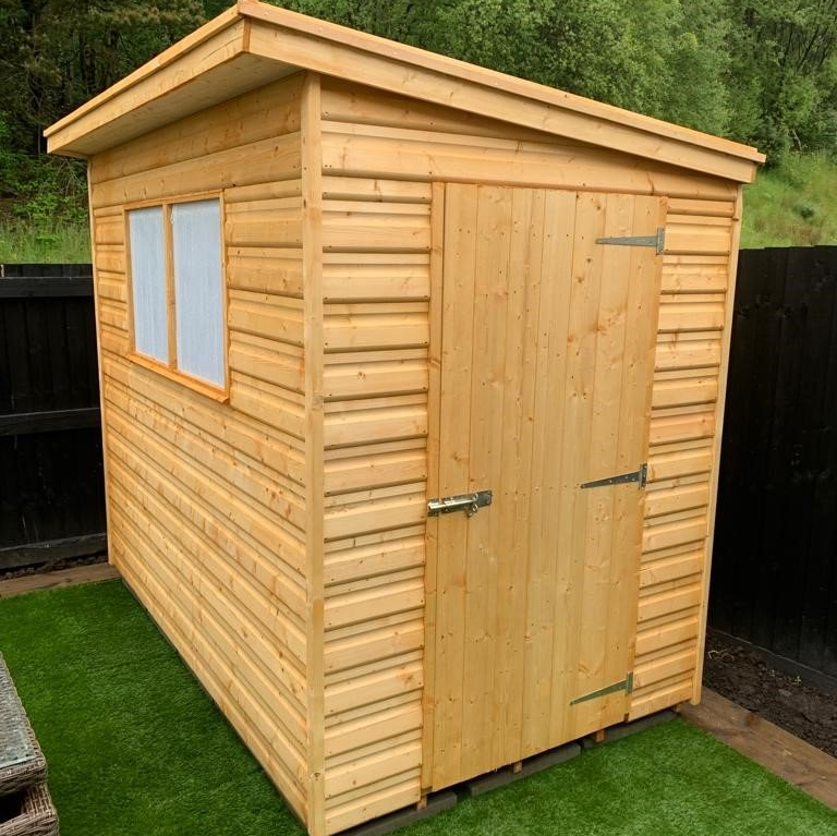 Pent Shed with door on the small side and window on the longer side. Sloping from the window panel to the other side.