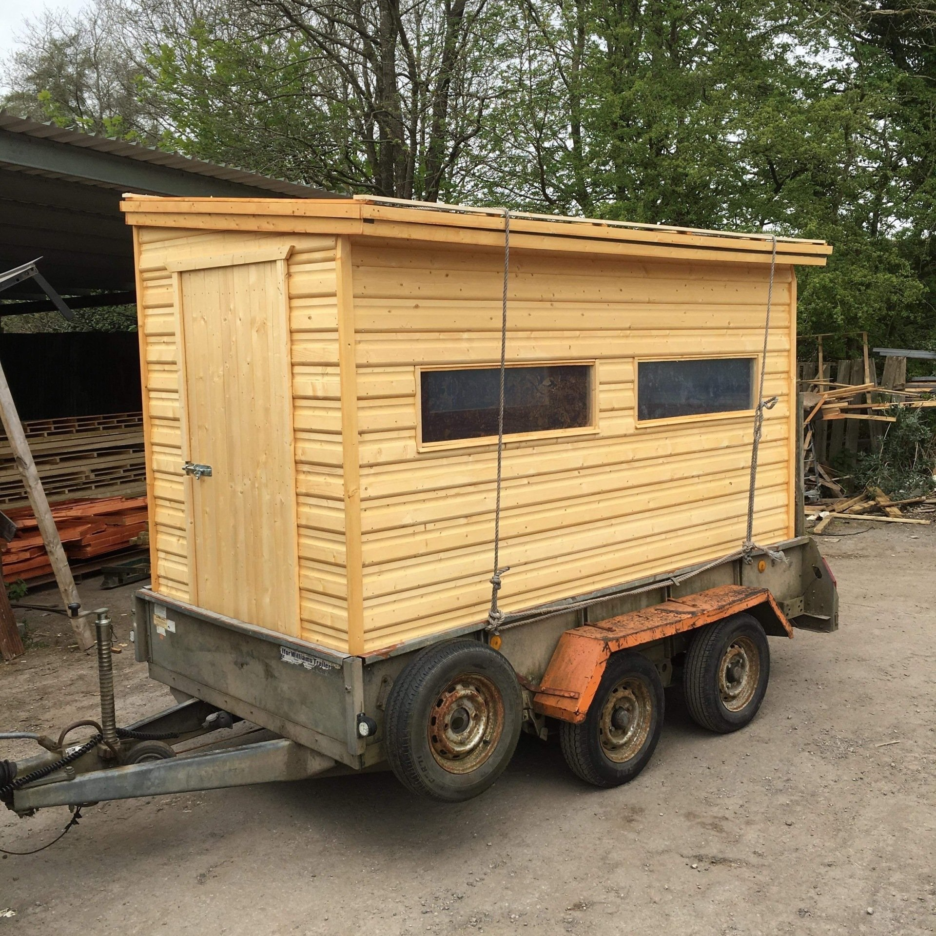 A moveable bird watching shed on a trailer. Trailer was brought to use and we built the building on that. It was painted in holly green to help camouflage while watching birds.