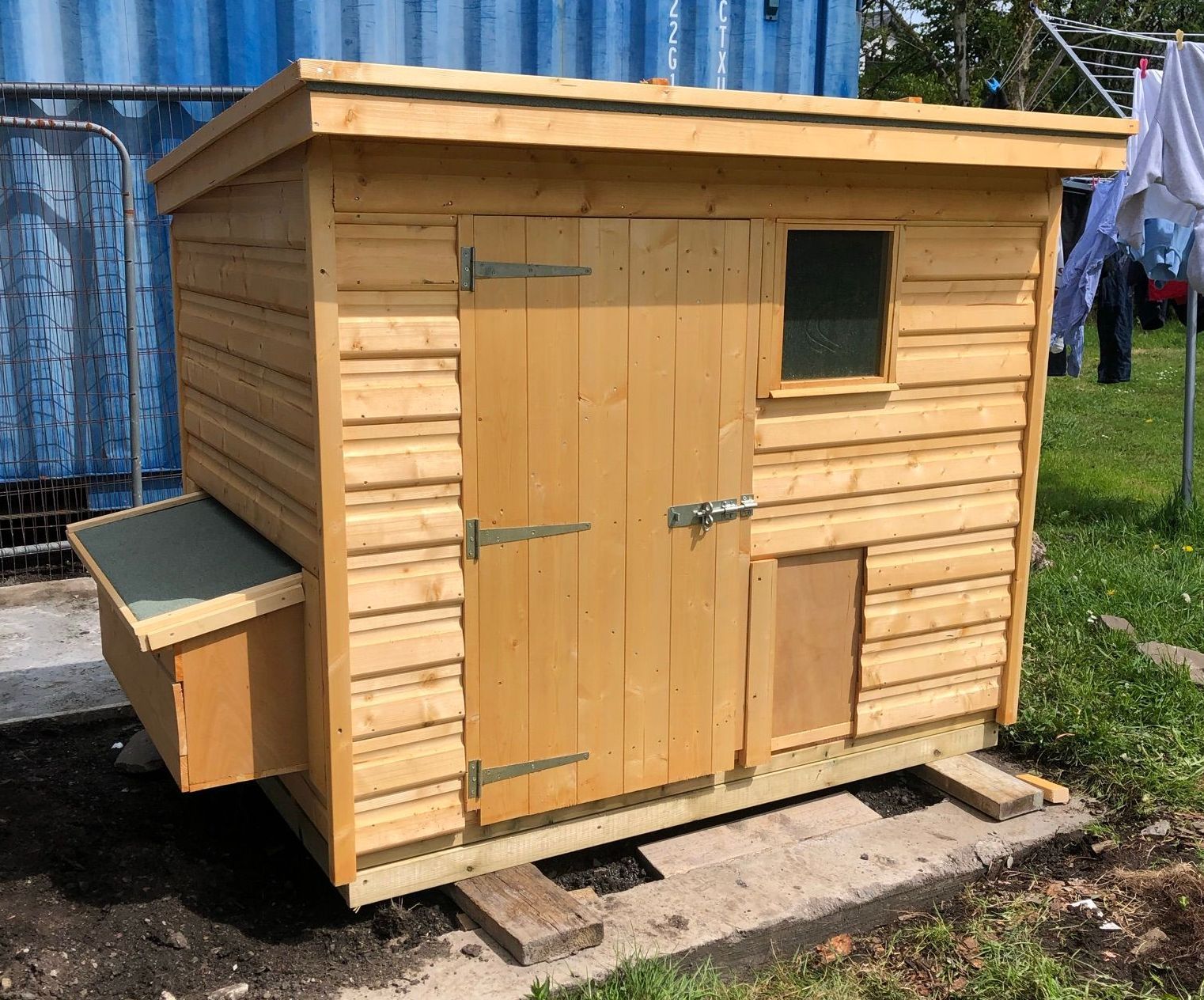 6' x 4' Low height chicken shed pent style. with nest box and shutter. Door for access inside to clean out. Small window to view.
