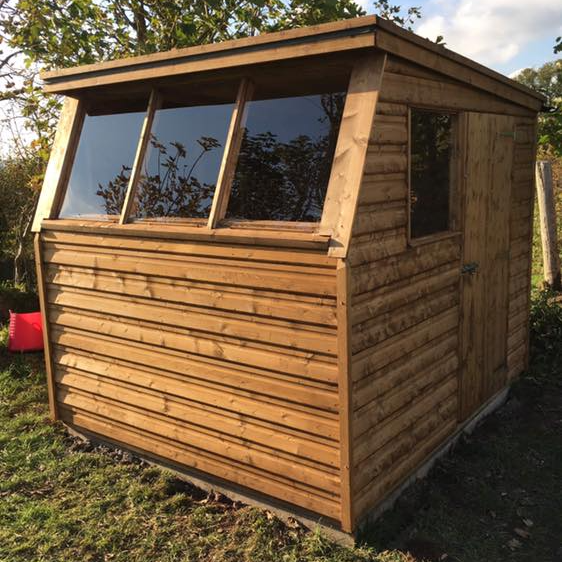 potting shed with smaller windows with additional window to the side.