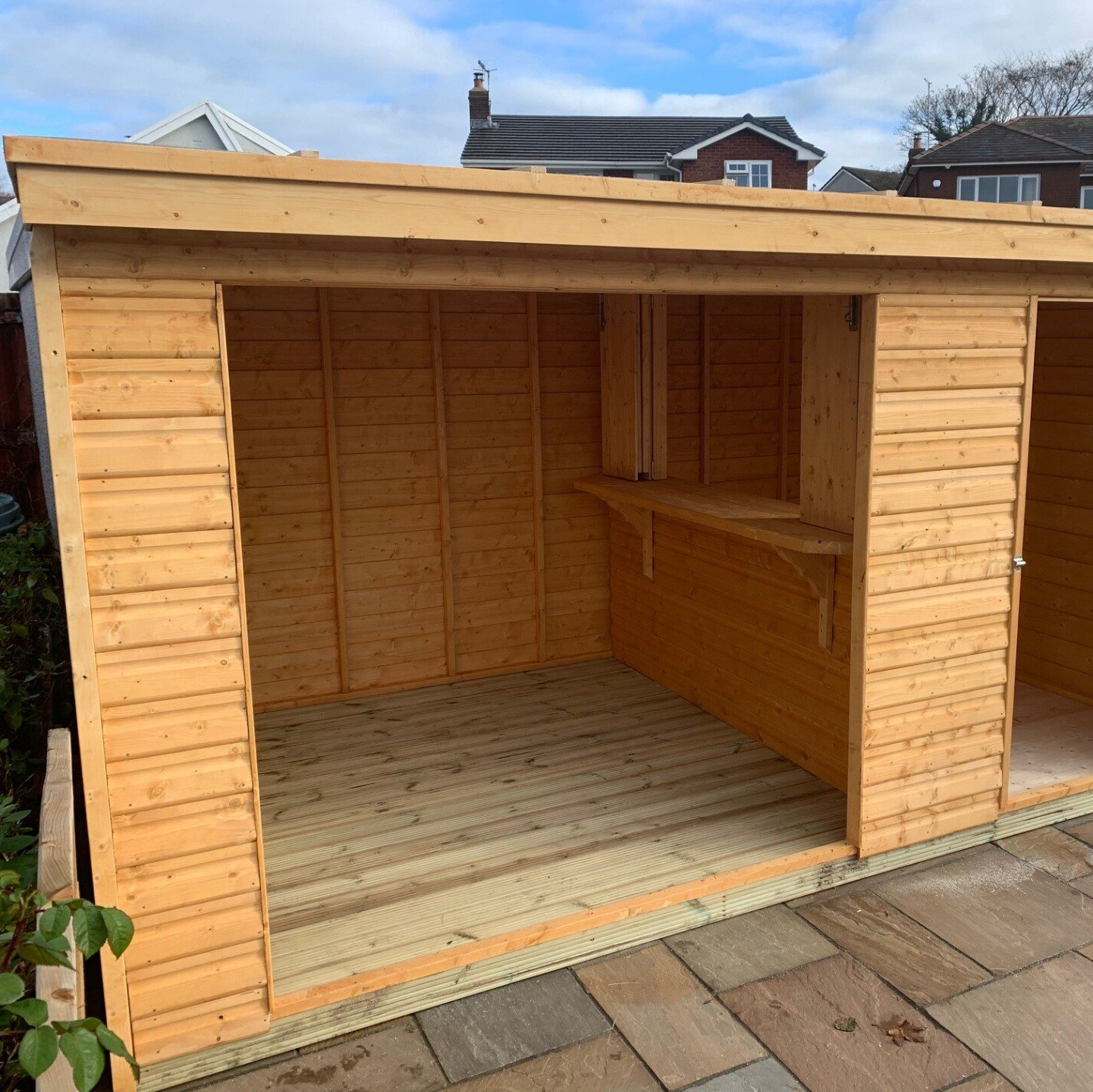 Pent style gazebo with a shed built in as a bar then decking flooring to stand hot tub or seating.