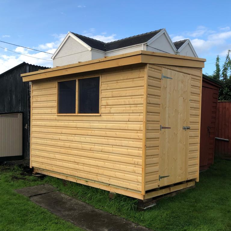 Pent shed with double windows on the long side and door on the short side.