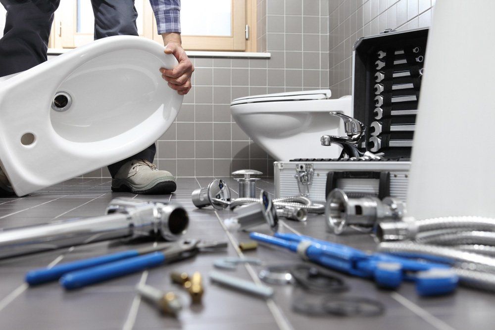 Plumber At Work In A Bathroom — Plumber in Dubbo NSW