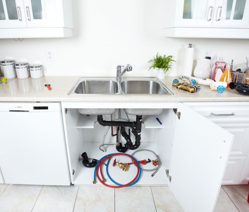 Plumbing Equipment Under Kitchen Sink — Plumber in Dubbo NSW