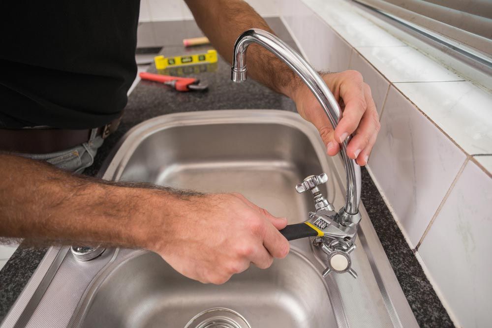 Plumber Replacing A Tap