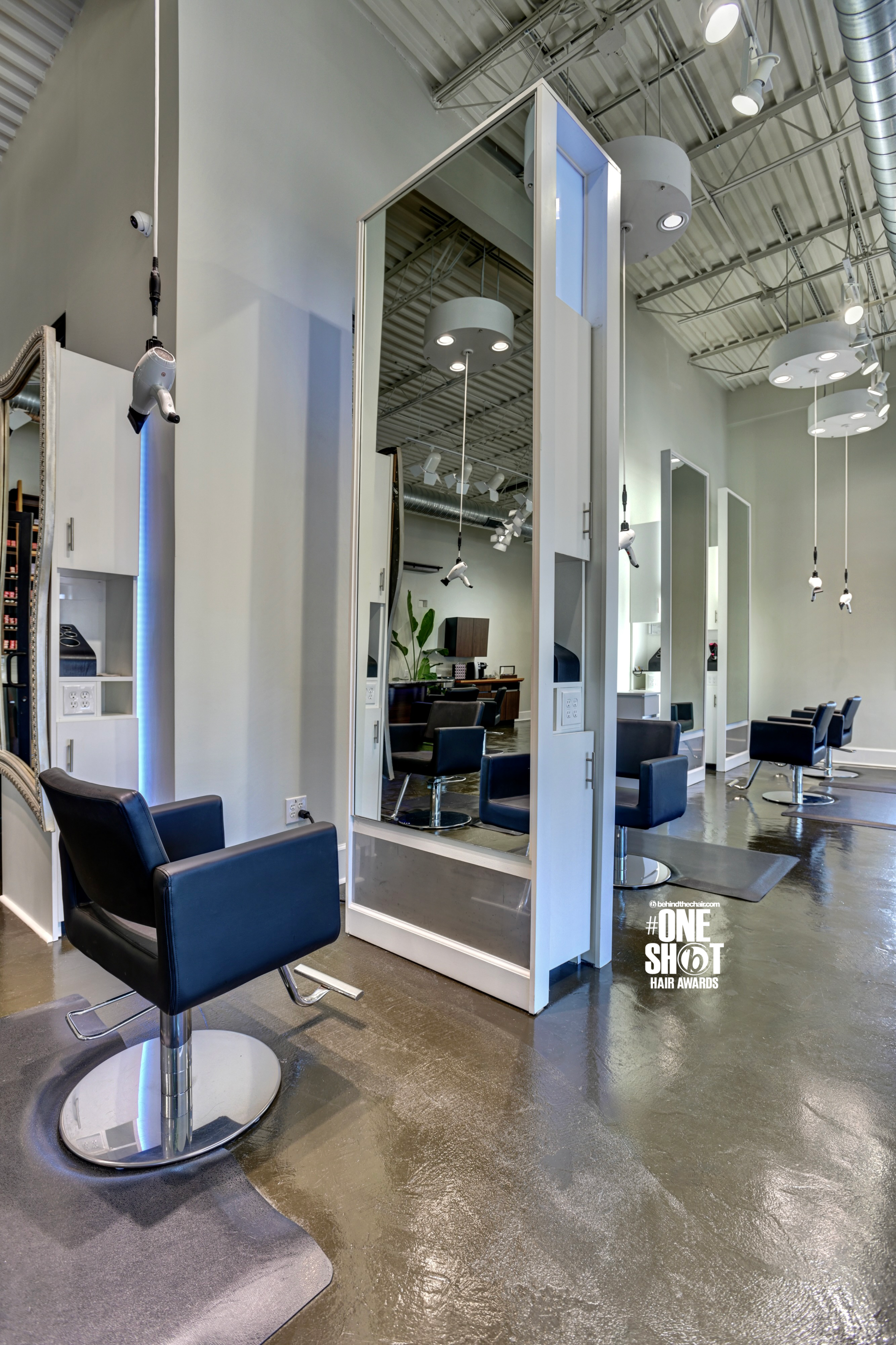 Brocatos Collective salon with a lot of chairs and mirrors