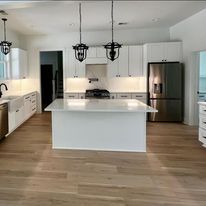 There is a large island in the middle of the kitchen.