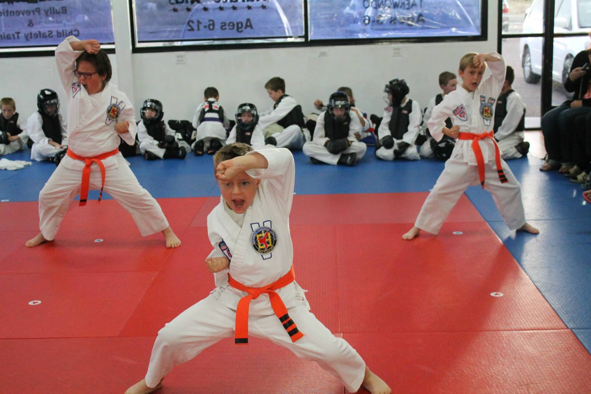 three boys wearing karate uniforms.