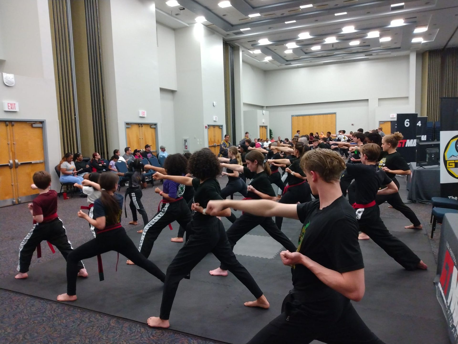 Many boys wear karate uniforms and do martial art.