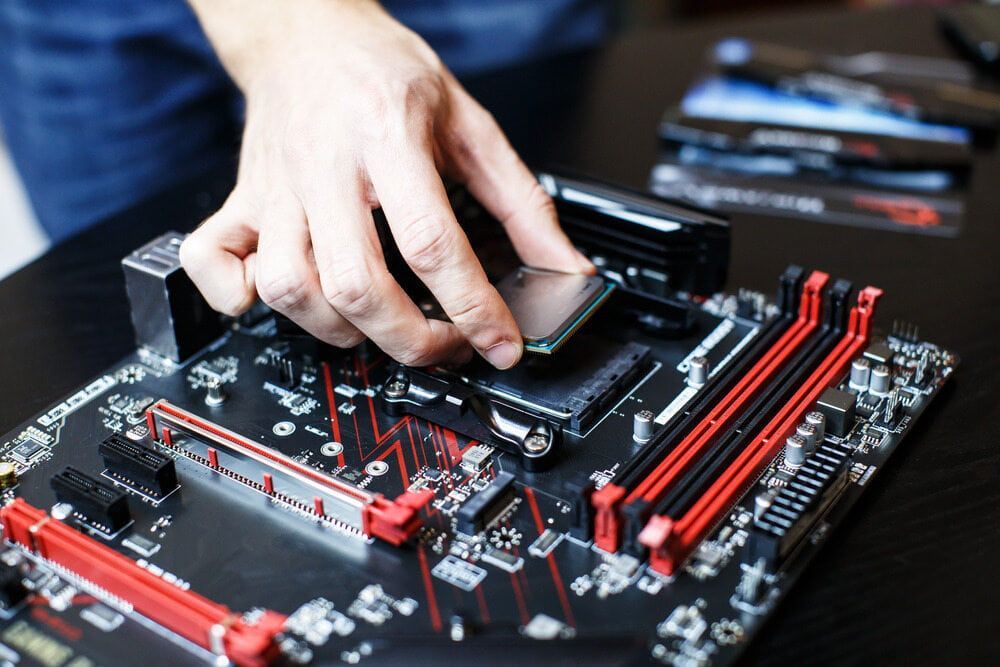 A Person Is Installing A Cpu On A Motherboard — Black Label I.T. in Garbutt, QLD