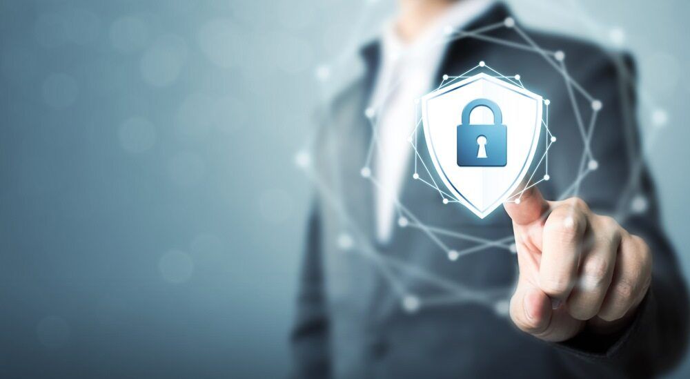 A Man In A Suit Is Touching A Shield With A Padlock — Black Label I.T. in Garbutt, QLD