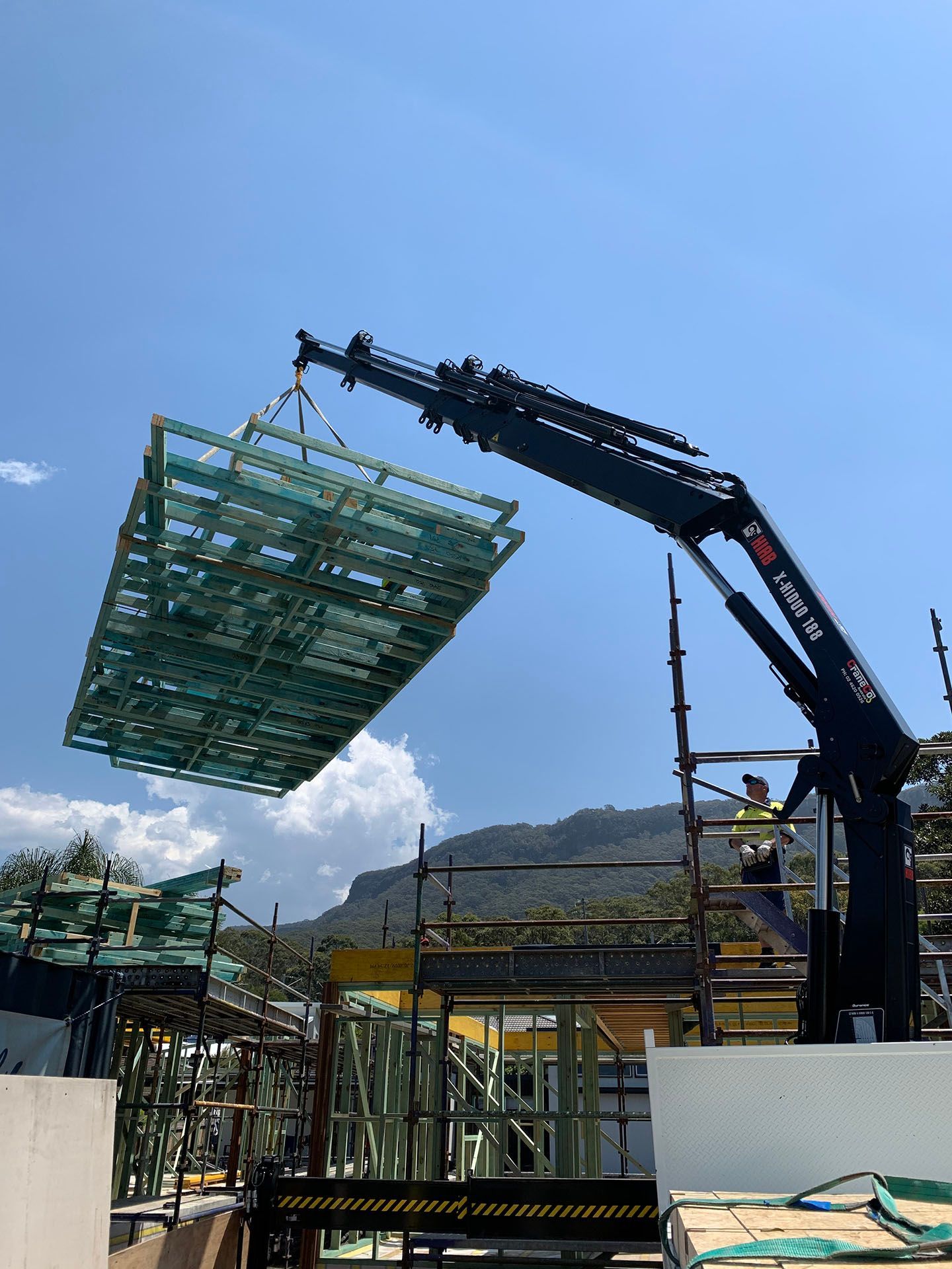 Crane lifting house frames