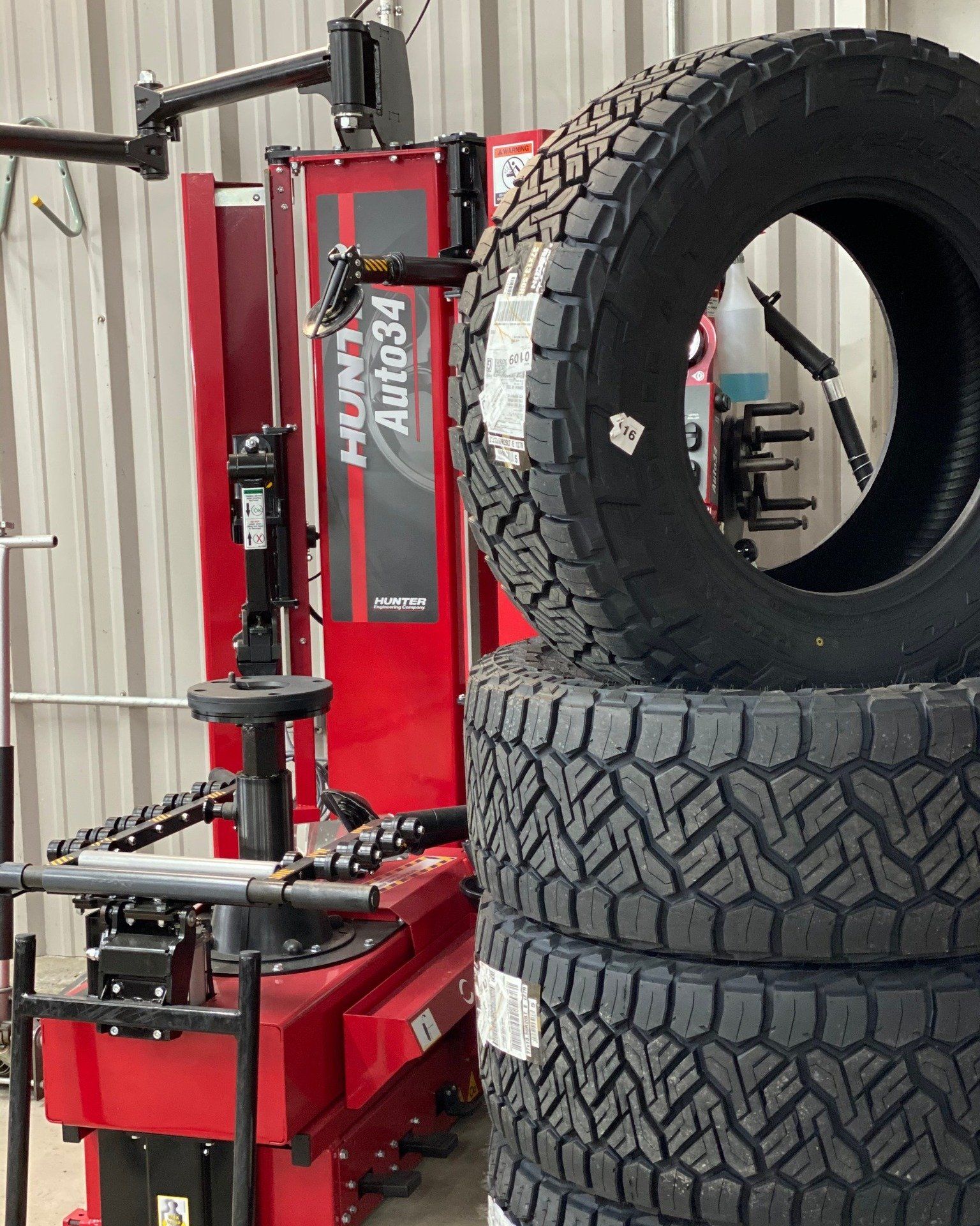 A stack of tires next to a machine that says auto34