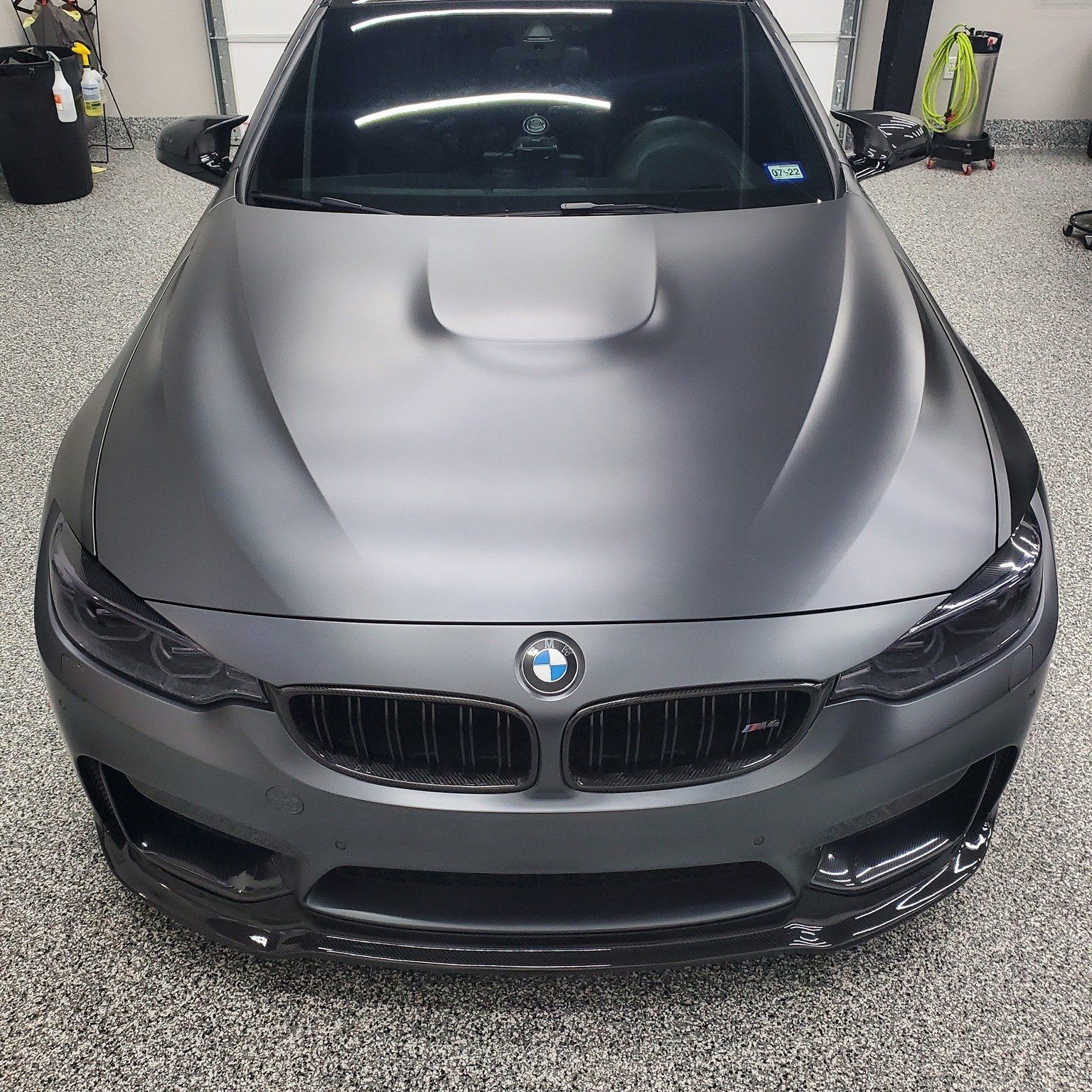 A bmw m4 is parked in a garage.
