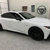 A white car is parked in a garage.