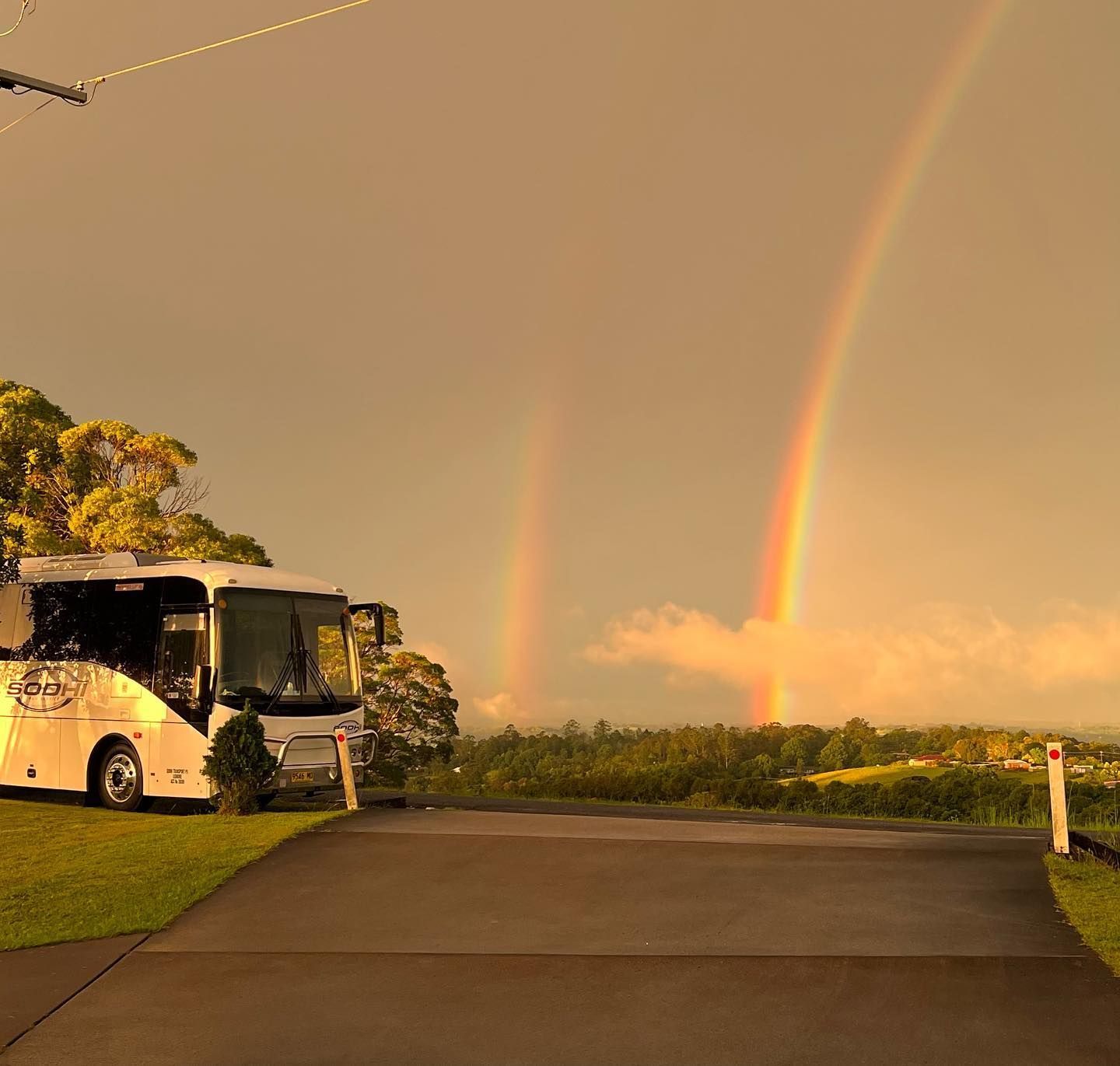 Tour Bus and eh rainbow scene — Local Bus Hire in Lismore, NSW