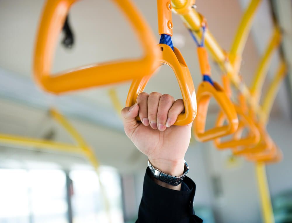 People Holding Onto A Handle — Local Bus Hire in Evans Head, NSW