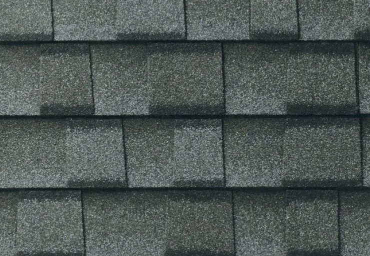 Gray asphalt shingles arranged in an overlapping pattern.