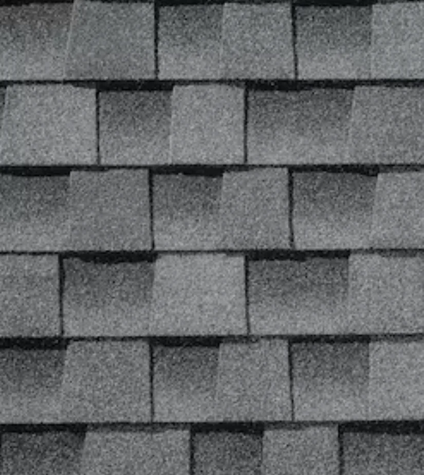 Gray asphalt roof shingles in a brick-like pattern.