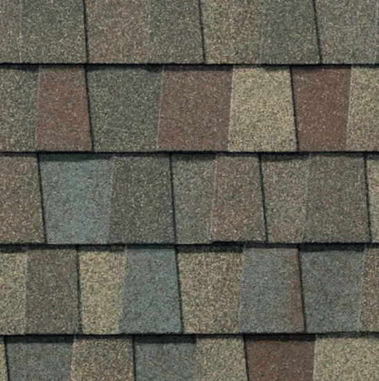 Overlapping asphalt roof shingles in shades of brown, gray, and blue-green.