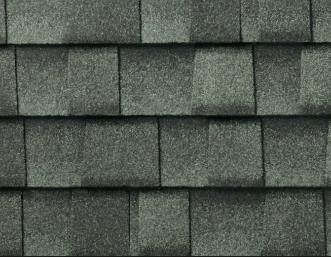 Close-up of overlapping gray asphalt roof shingles.
