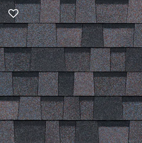 Close-up of asphalt roof shingles in shades of gray and black, showing a textured, layered pattern.