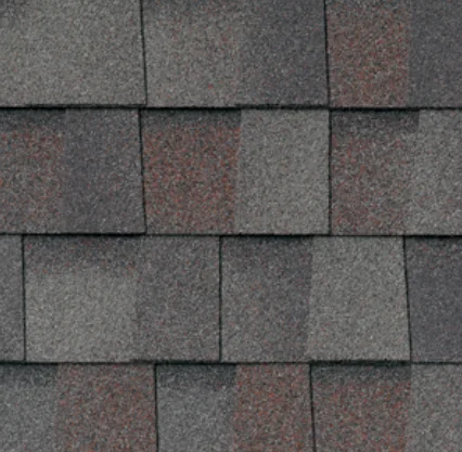 Close-up of asphalt roof shingles in shades of gray and brown.