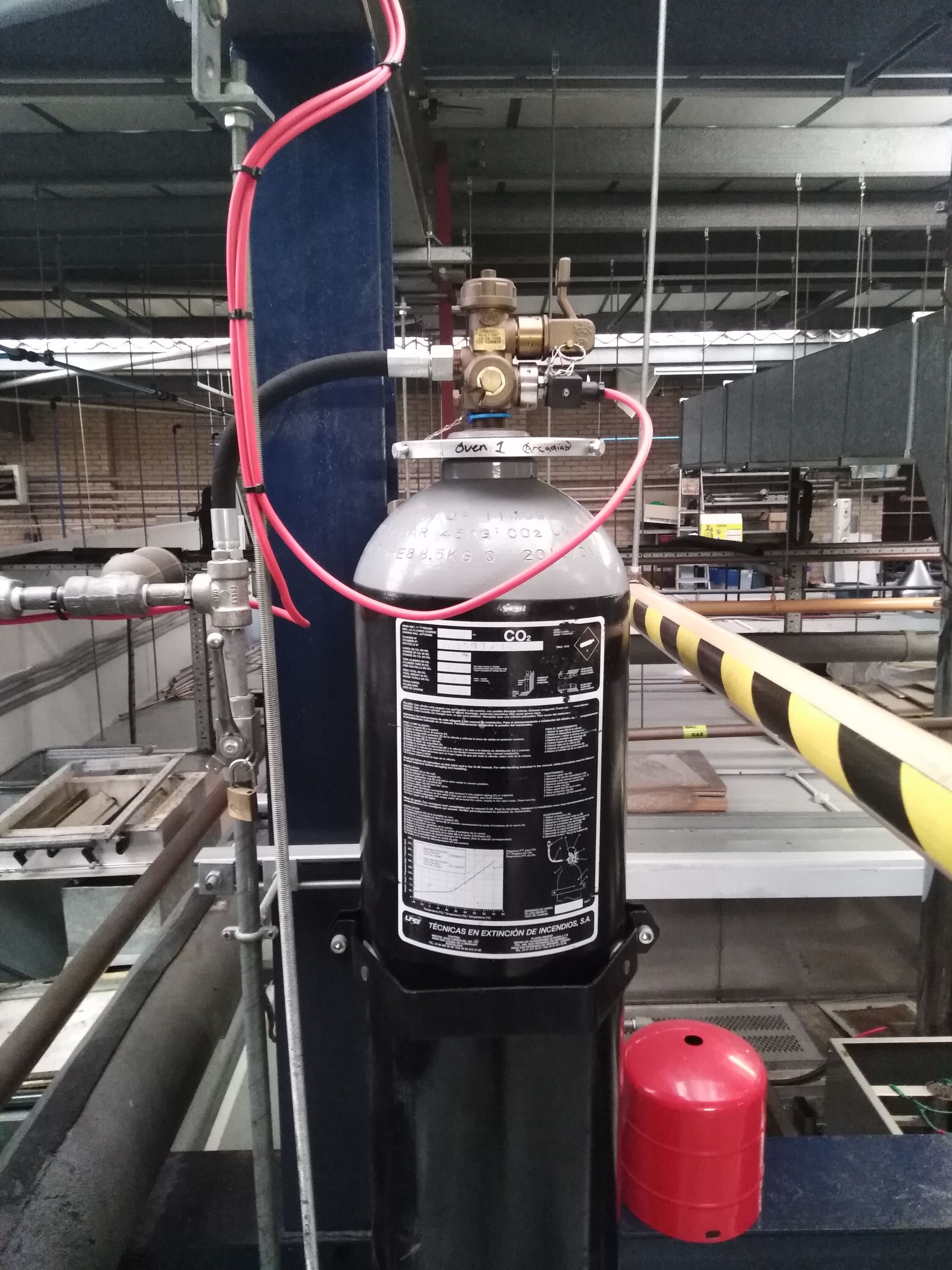 A black cylinder with a white label that says ' fire extinguisher ' on it