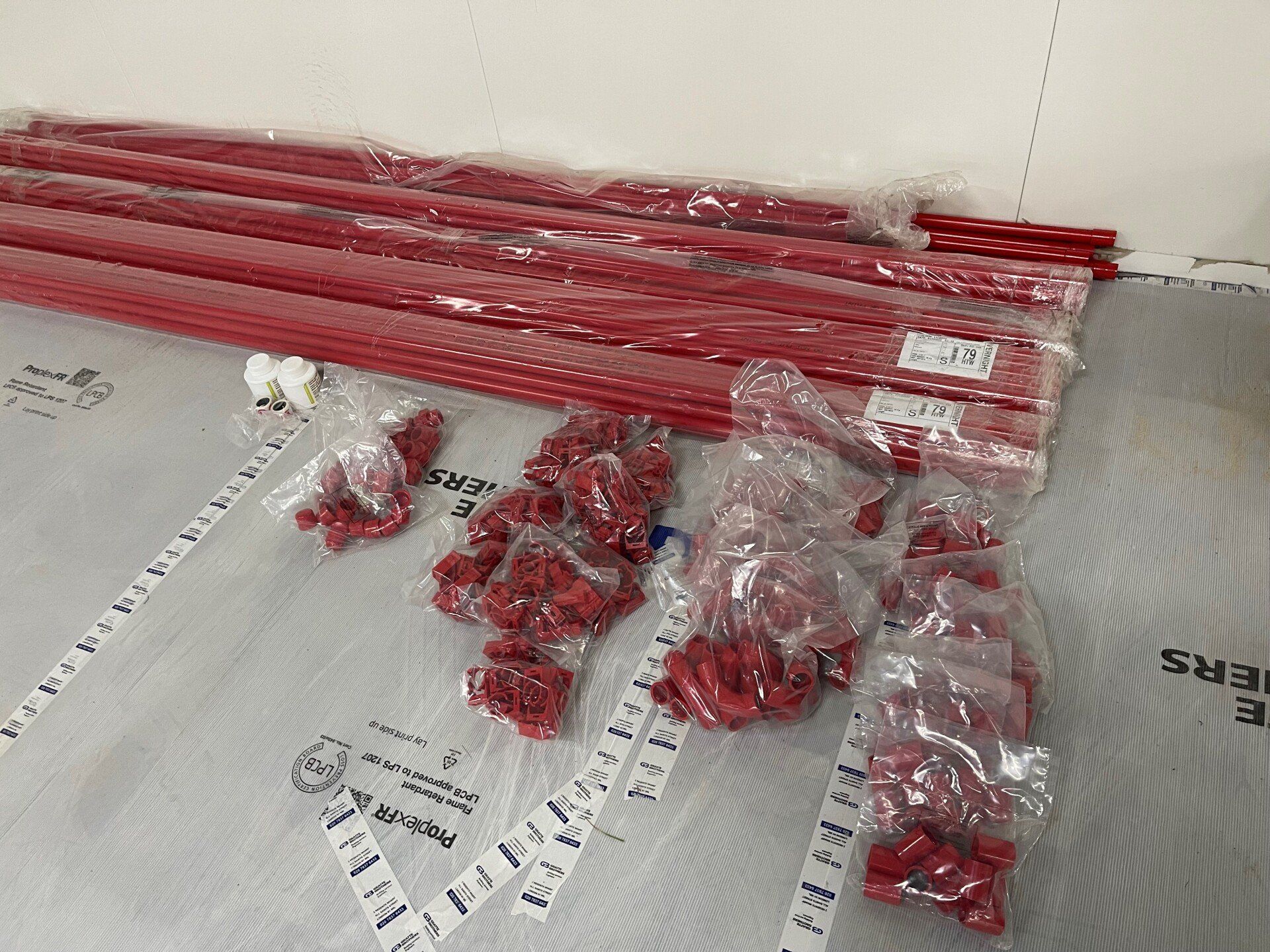 A bunch of red plastic bags are sitting on a table.