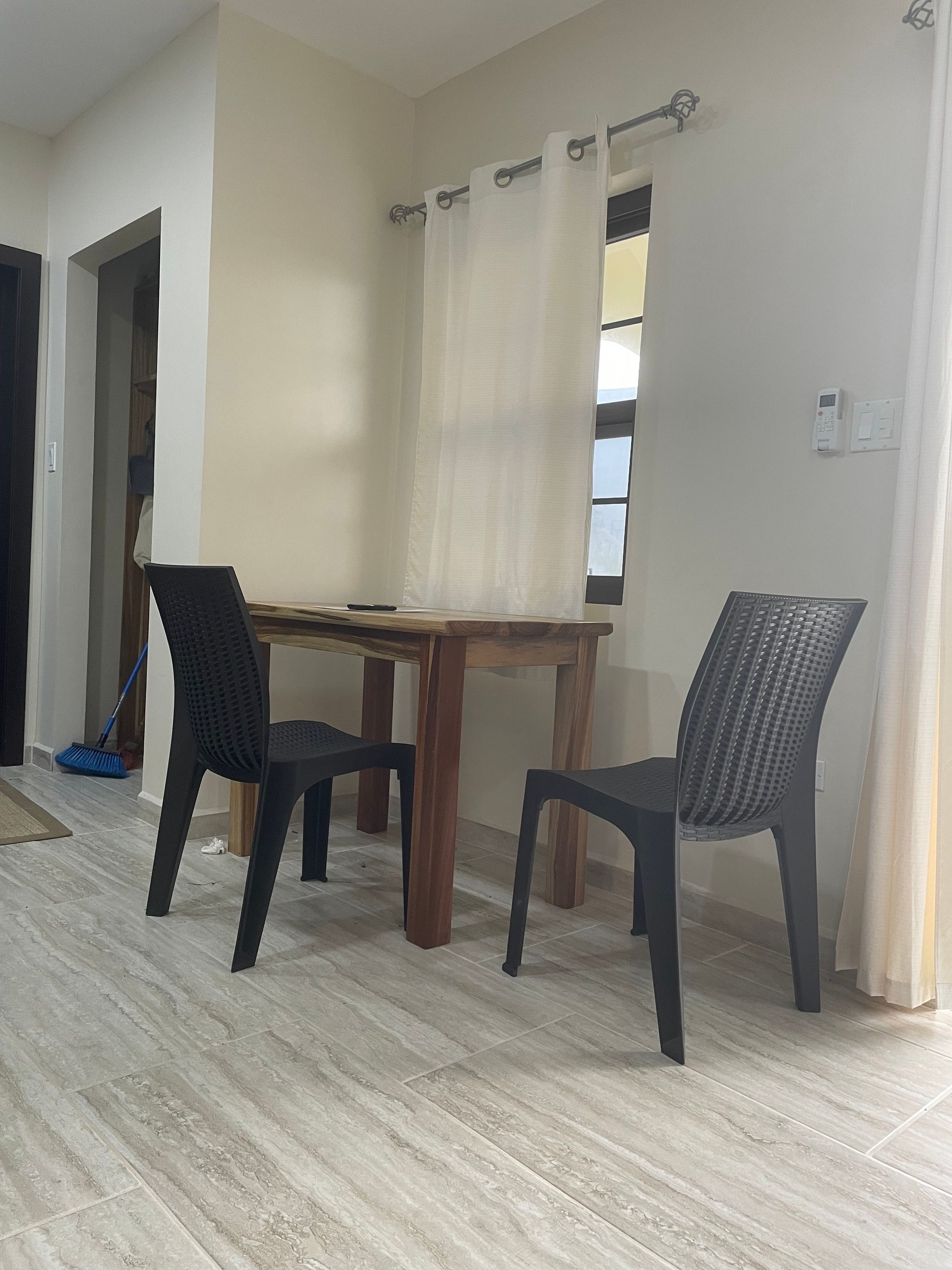 Toucan Suite with two chairs and a table in the room.