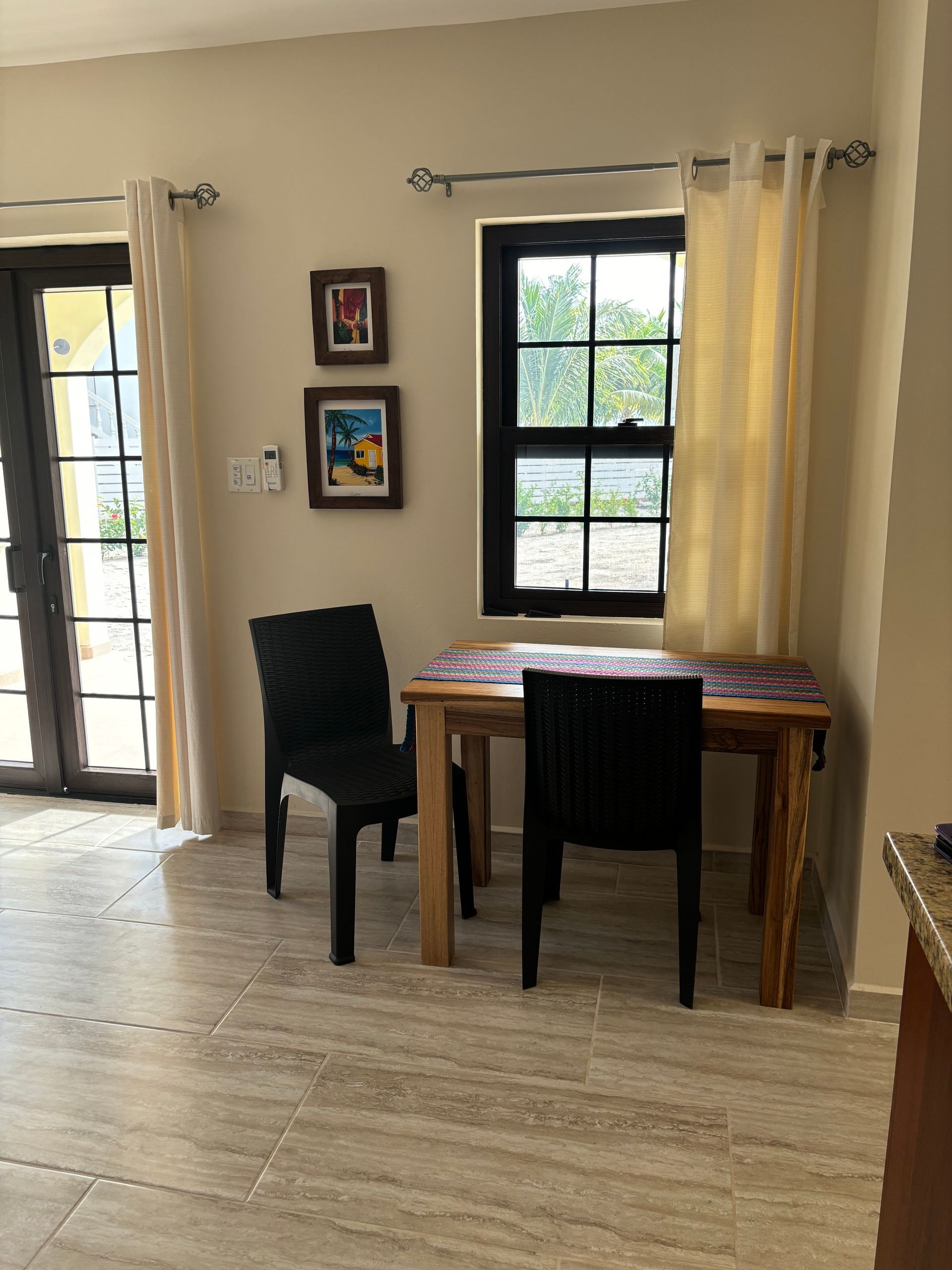 Toucan Suite dining room with a table and chairs in front of a window.