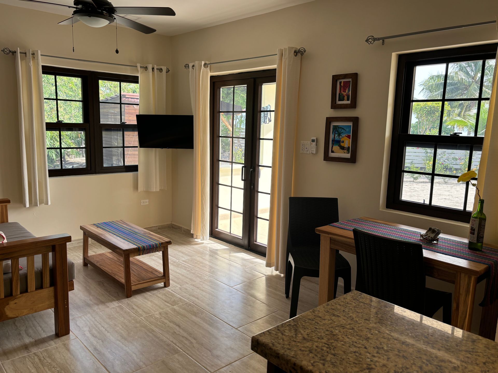 Toucan Suite living room with a table , chairs , and a flat screen tv.