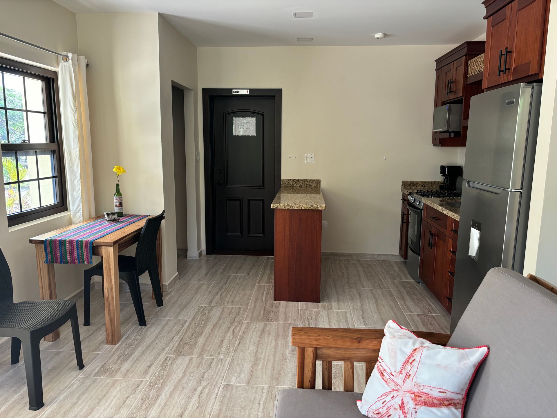 Toucan Suite living room with a table and chairs and a kitchen