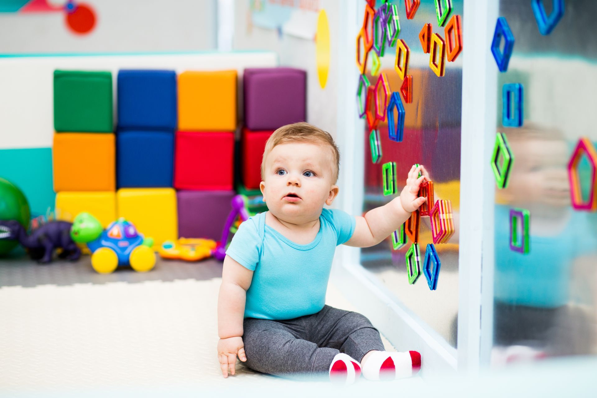 Baby Playing with Colorful Magnets.