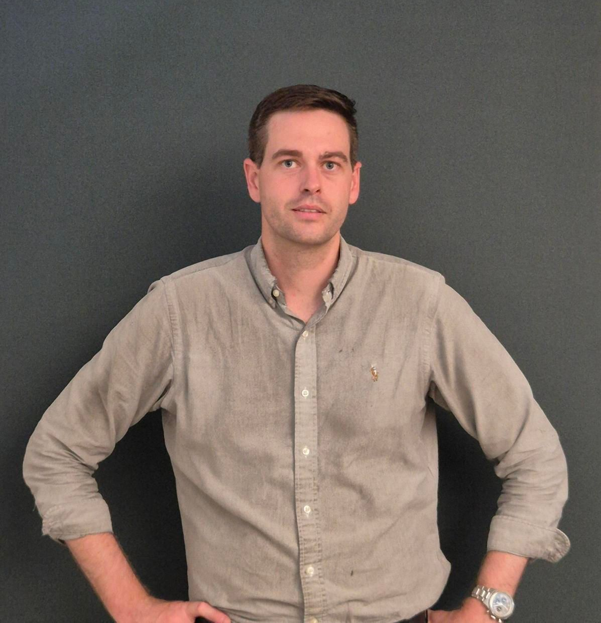 Businesspeople reviewing documents at a conference table, discussing data; window in background.