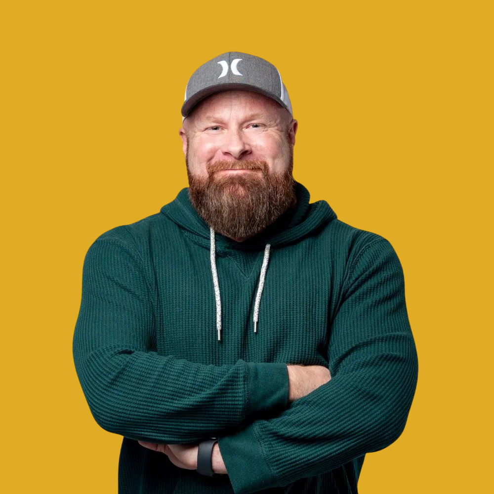 CEO Jono Long - with a beard is wearing a green hoodie and a hat .