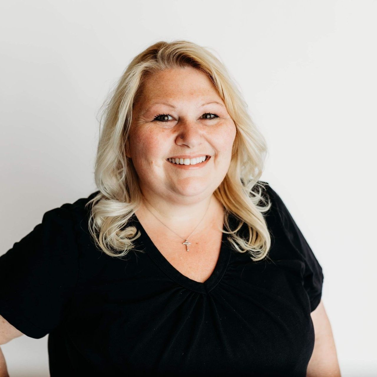 A woman wearing a black faithworks marketing t-shirt