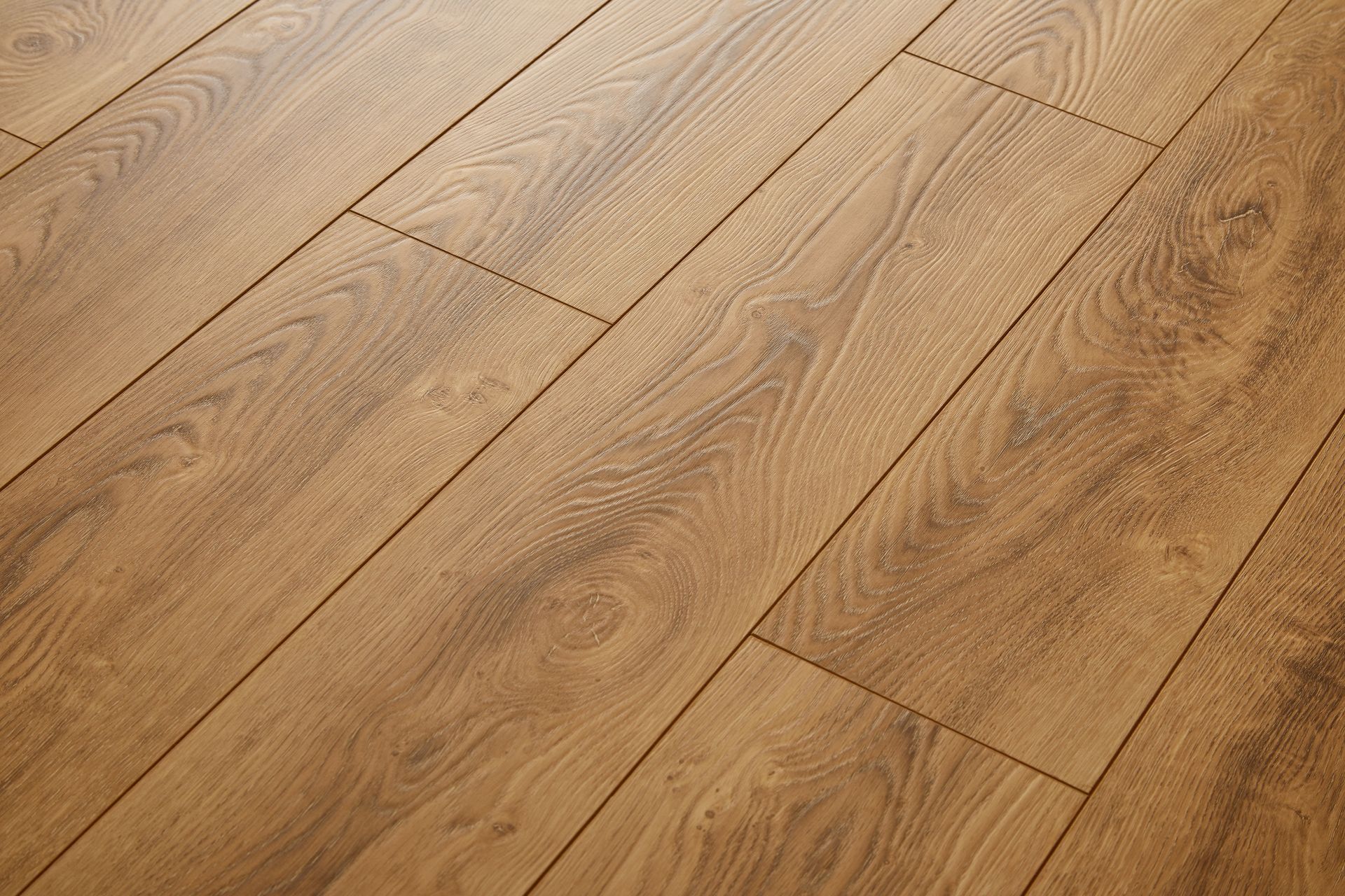Light brown wooden floorboards with a natural grain pattern and plank seams.