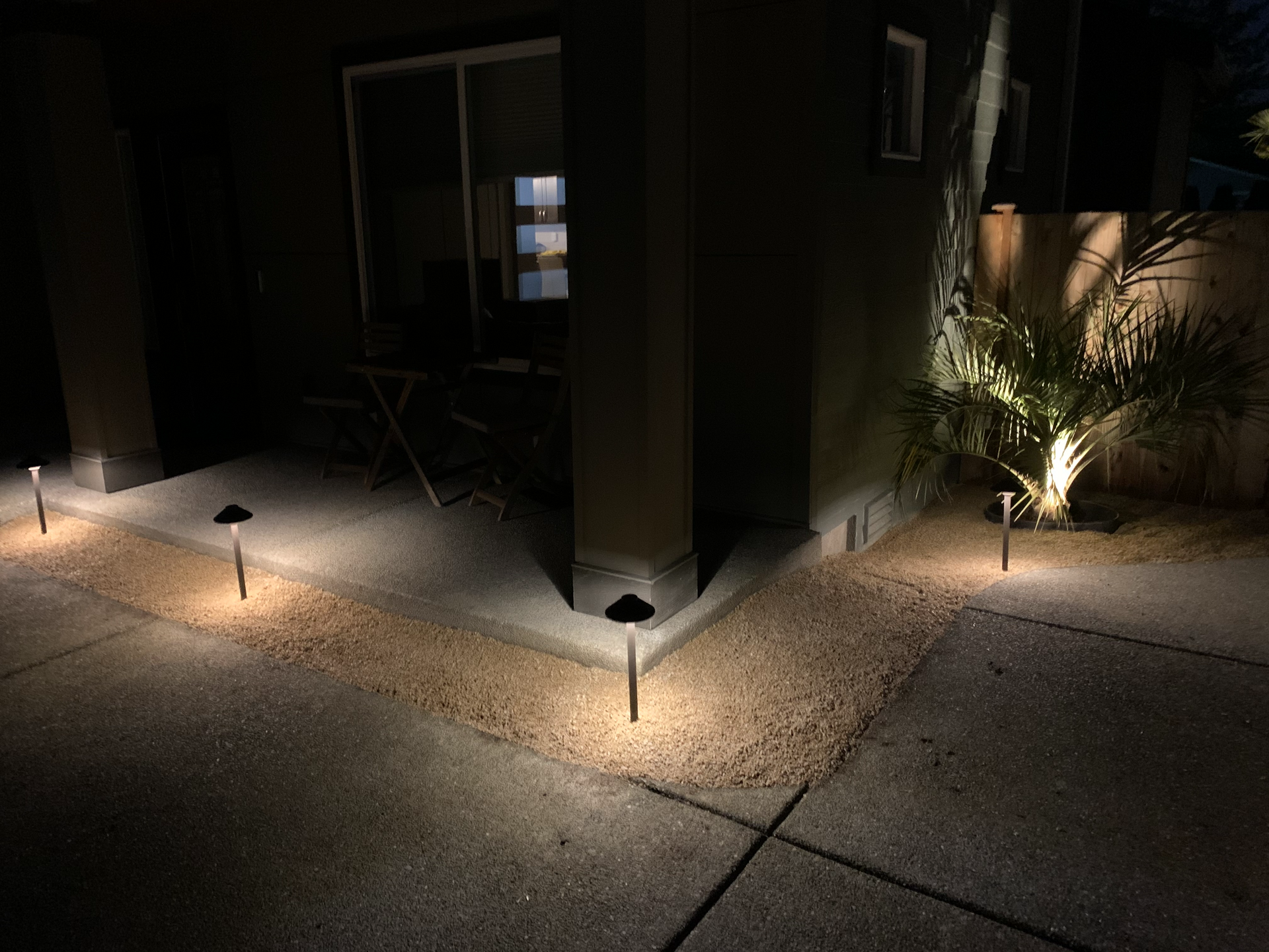 A patio with a lot of lights on it at night.