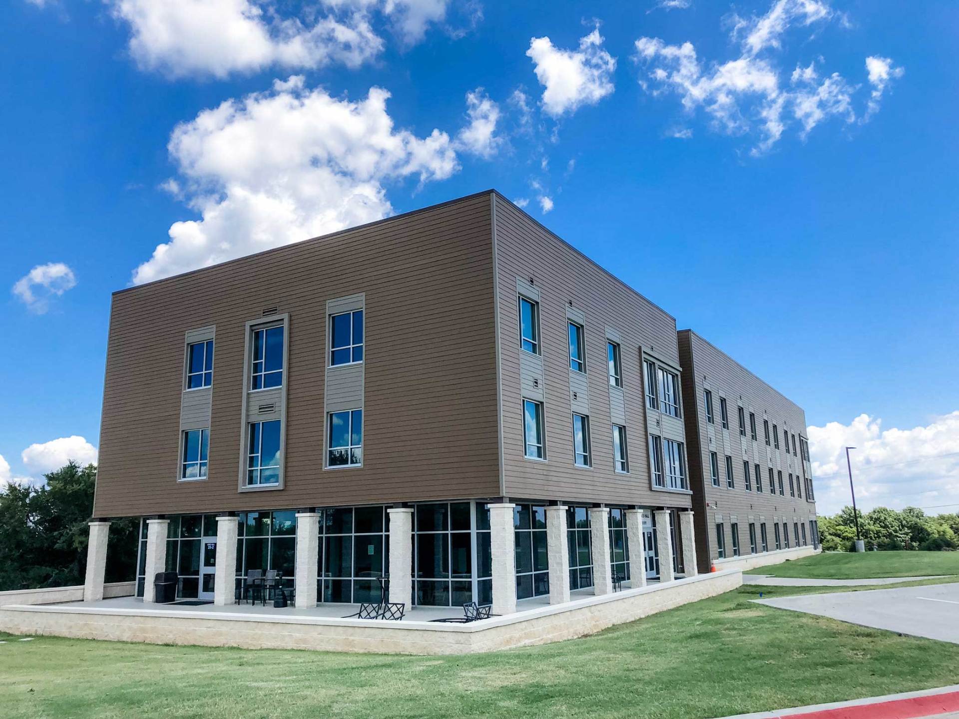 A commercial siding job in Denison, Texas, of a 3-story college dormitory.